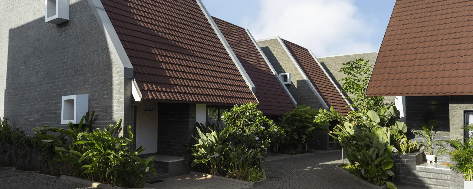 Red-roofed A-frame houses amid greenery